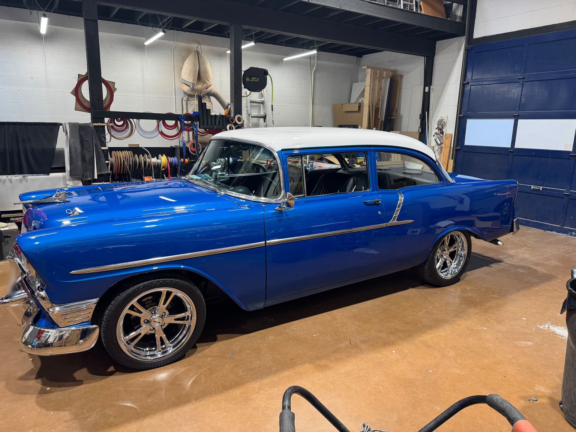 Blue and white 1956 Chevrolet in the Audiomotivez install bay